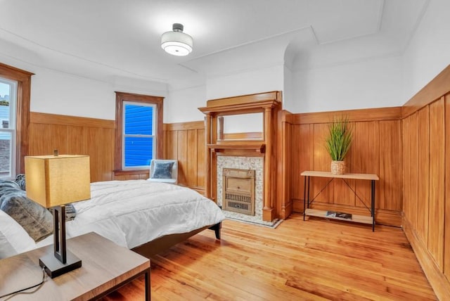 bedroom with hardwood / wood-style flooring and wood walls