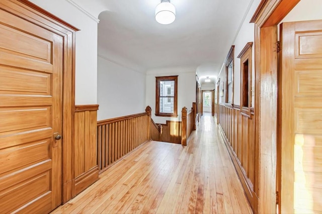 corridor with light hardwood / wood-style floors