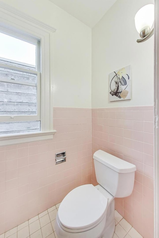 bathroom featuring tile walls, toilet, and tile patterned flooring