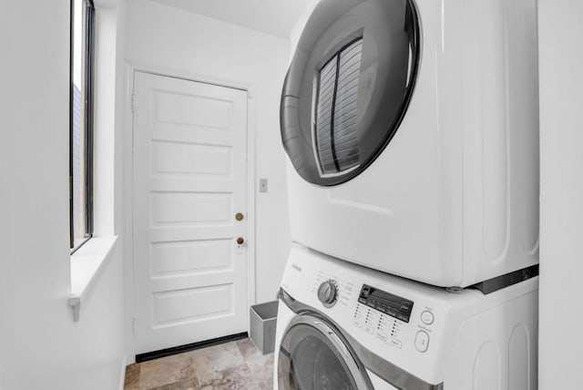 washroom with stacked washer and dryer