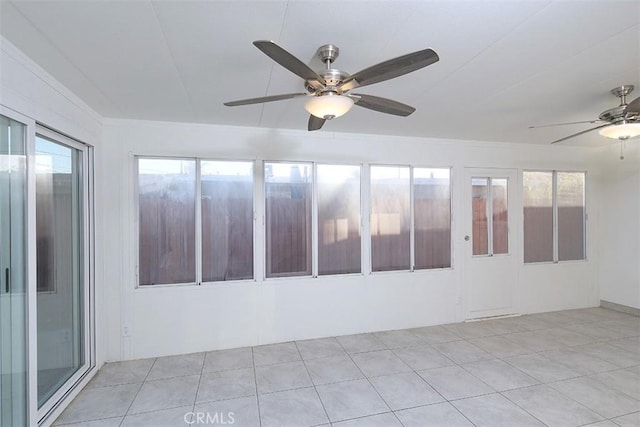 spare room with ceiling fan and light tile patterned floors