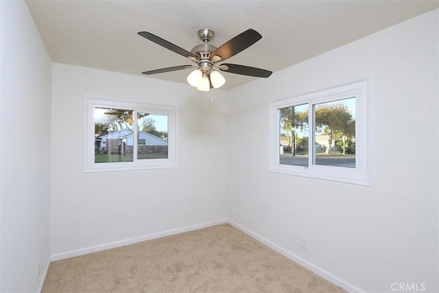 carpeted empty room featuring ceiling fan