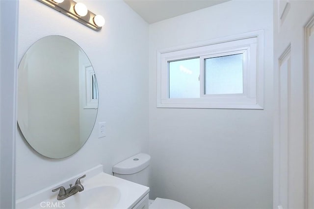 bathroom featuring toilet and vanity