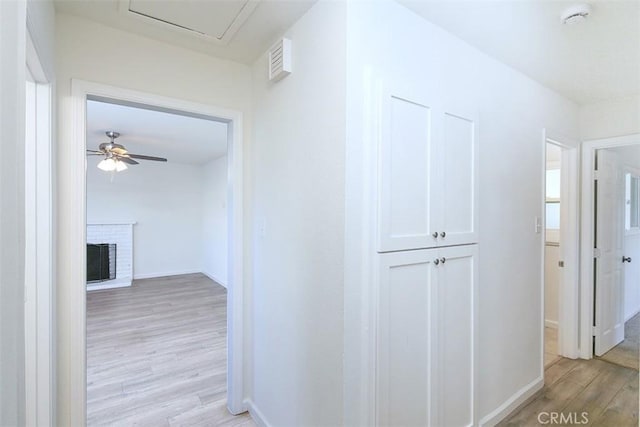 hallway with light hardwood / wood-style flooring