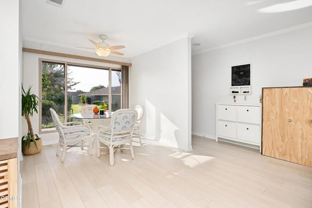 dining area with light hardwood / wood-style flooring, ceiling fan, and crown molding