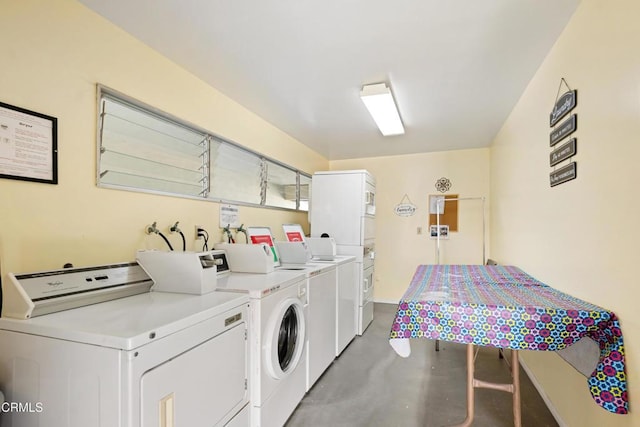 clothes washing area with washer and dryer