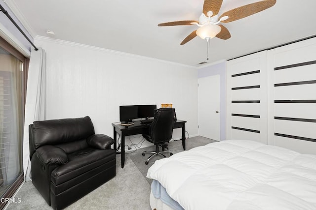 bedroom featuring ceiling fan, crown molding, and light colored carpet