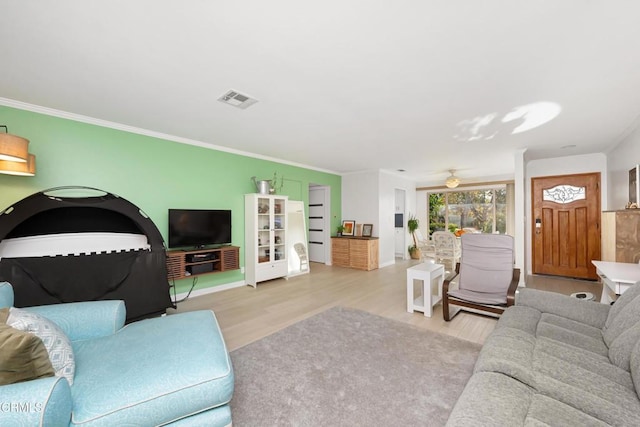 living room featuring ceiling fan, light hardwood / wood-style flooring, and ornamental molding