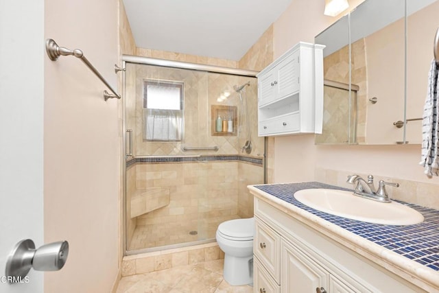 bathroom with tile patterned flooring, vanity, toilet, and a shower with shower door