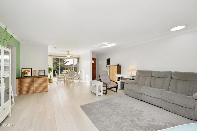 living room featuring hardwood / wood-style flooring, ceiling fan, and crown molding