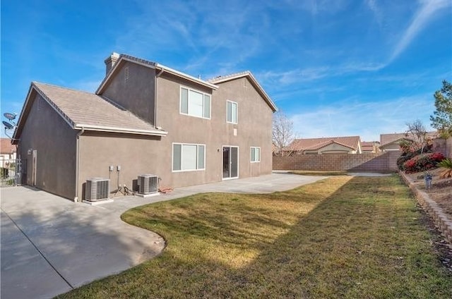 back of house with a lawn, a patio area, and central AC unit