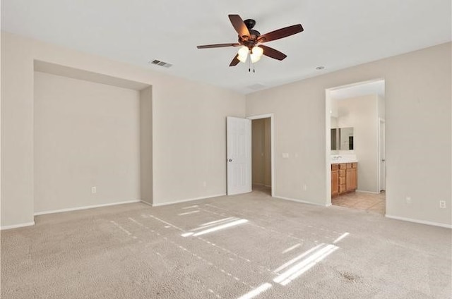 carpeted spare room featuring ceiling fan