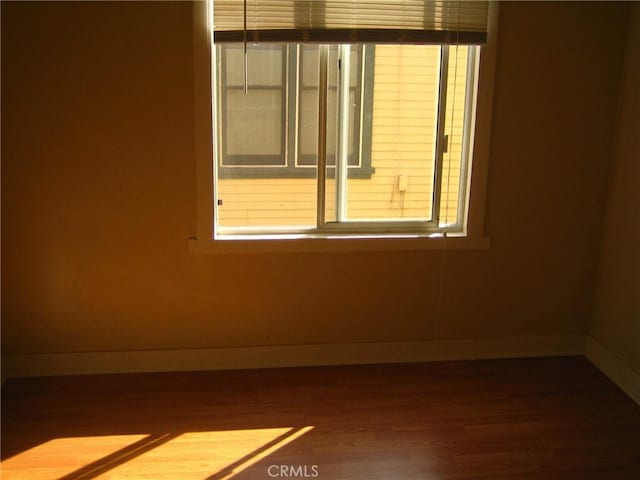 spare room with hardwood / wood-style floors