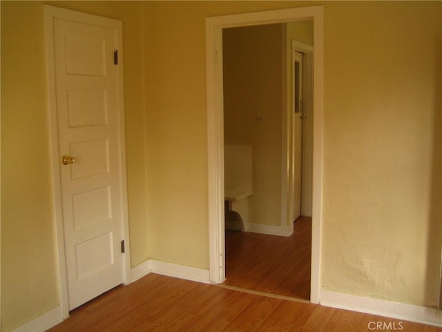 empty room with hardwood / wood-style floors