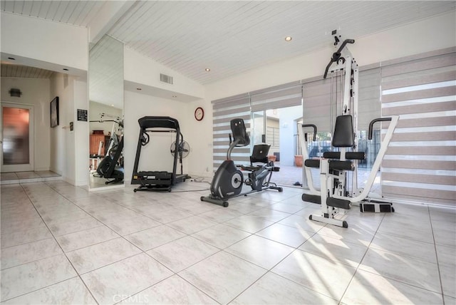 exercise room featuring light tile patterned floors, wood ceiling, and vaulted ceiling