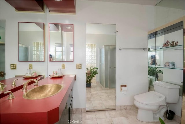 bathroom with tile patterned flooring, vanity, toilet, and walk in shower