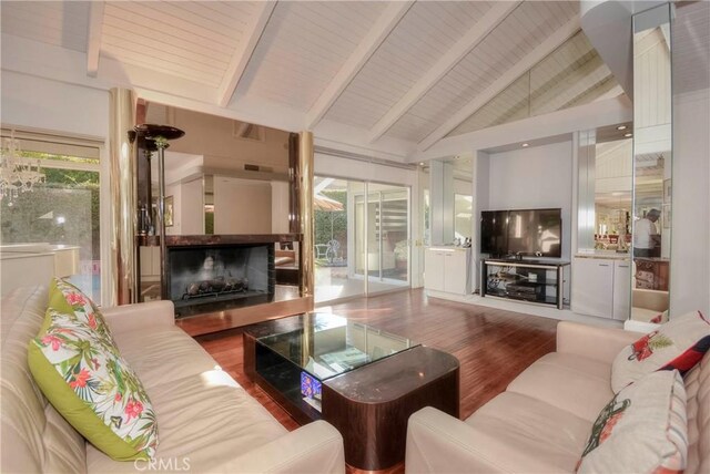 living room featuring wooden ceiling, high vaulted ceiling, hardwood / wood-style flooring, a fireplace, and beamed ceiling