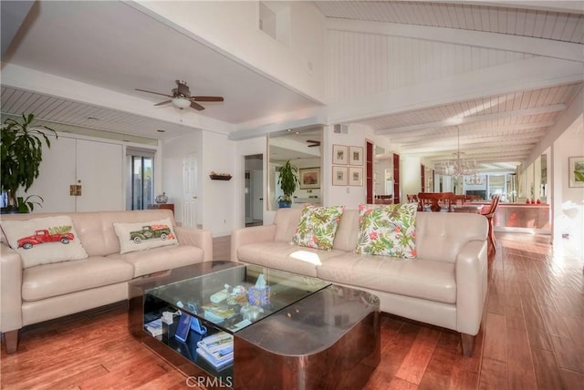 living room featuring lofted ceiling with beams, ceiling fan with notable chandelier, and hardwood / wood-style flooring