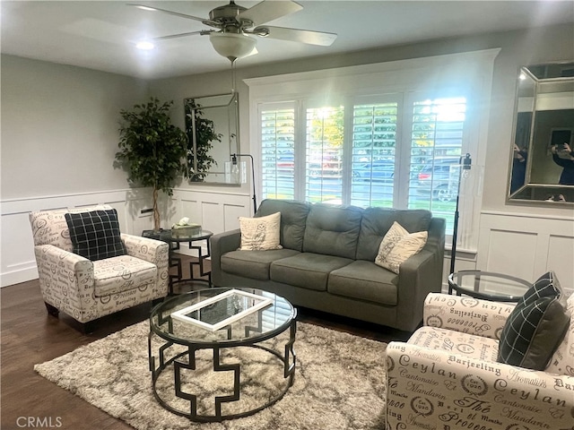 living room featuring ceiling fan and dark hardwood / wood-style flooring