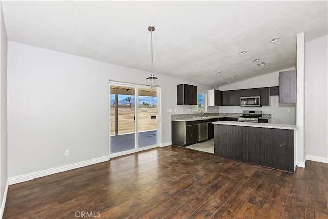 kitchen with sink, vaulted ceiling, dark hardwood / wood-style floors, appliances with stainless steel finishes, and dark brown cabinets