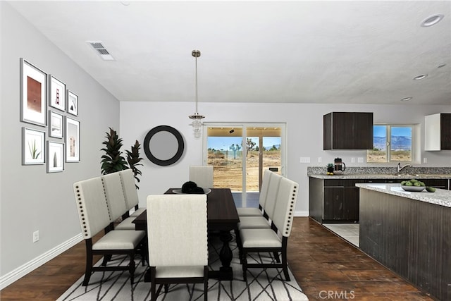 dining area featuring dark hardwood / wood-style flooring and sink