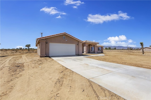 ranch-style home featuring a garage