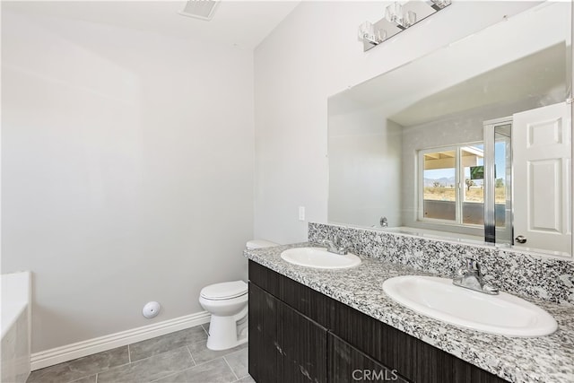 bathroom featuring tile patterned flooring, vanity, and toilet