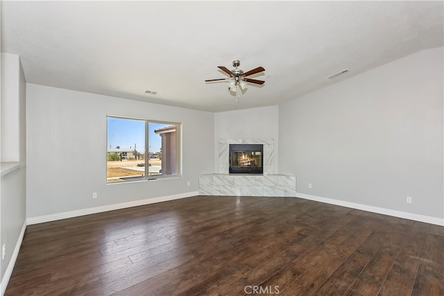 unfurnished living room with ceiling fan, dark hardwood / wood-style flooring, a fireplace, and vaulted ceiling