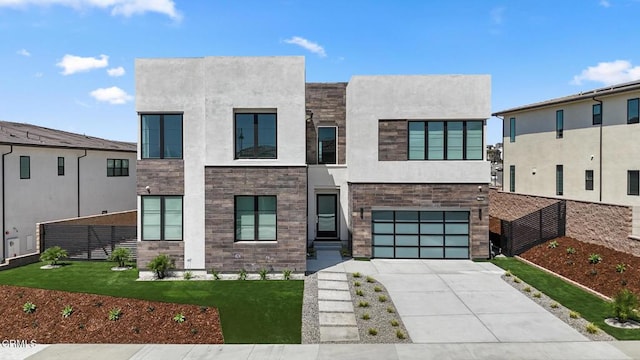 contemporary house with a front yard and a garage