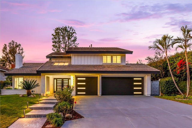 view of front of home featuring a garage and a lawn