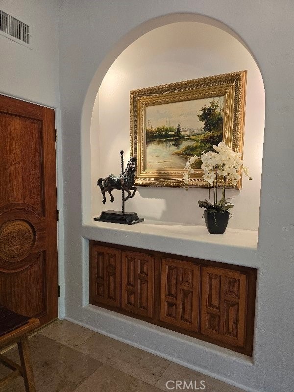 hall with dark tile patterned flooring