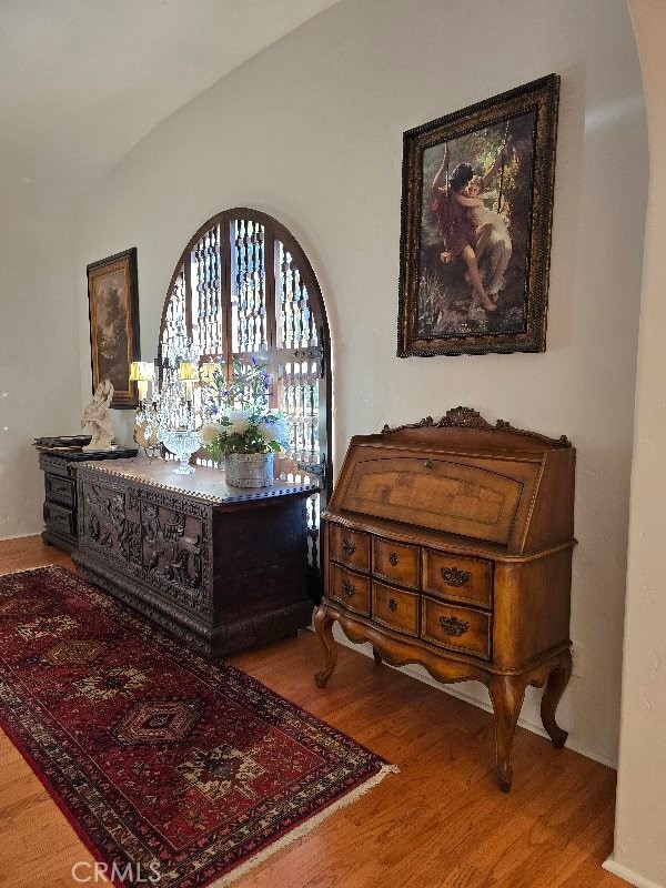 bedroom with hardwood / wood-style floors and vaulted ceiling