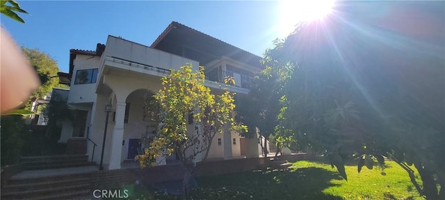 view of side of home with a yard