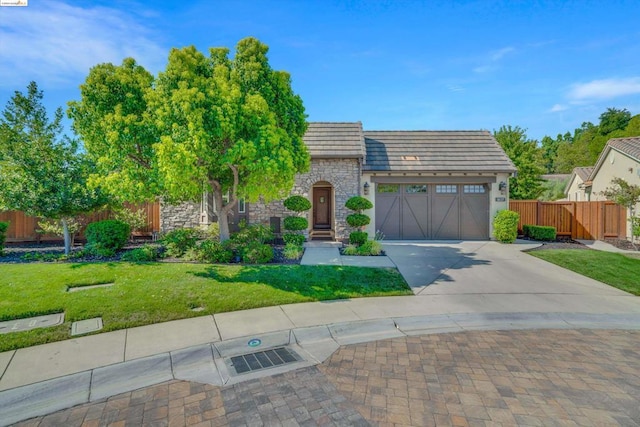 view of front of home with a front lawn and a garage