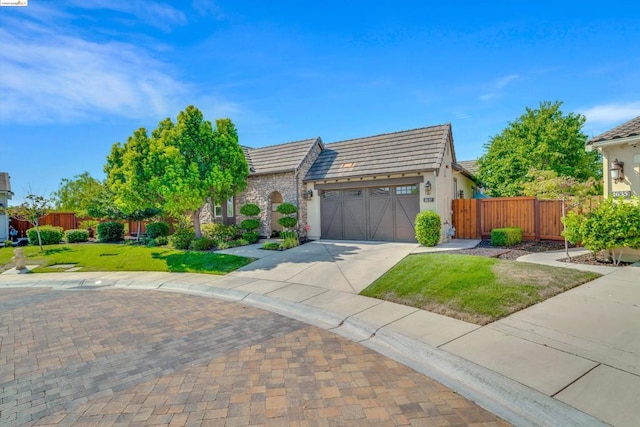 view of front of home with a front lawn and a garage