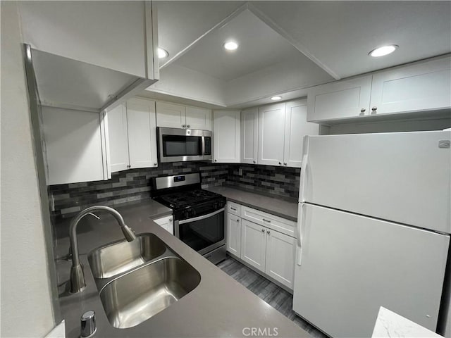 kitchen with white cabinetry, sink, and appliances with stainless steel finishes