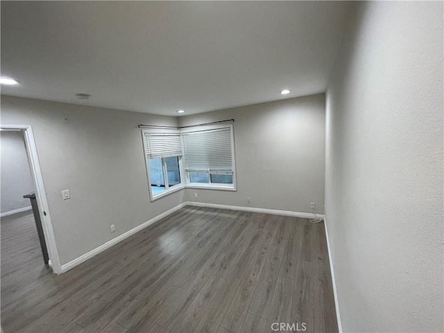 unfurnished room with hardwood / wood-style floors