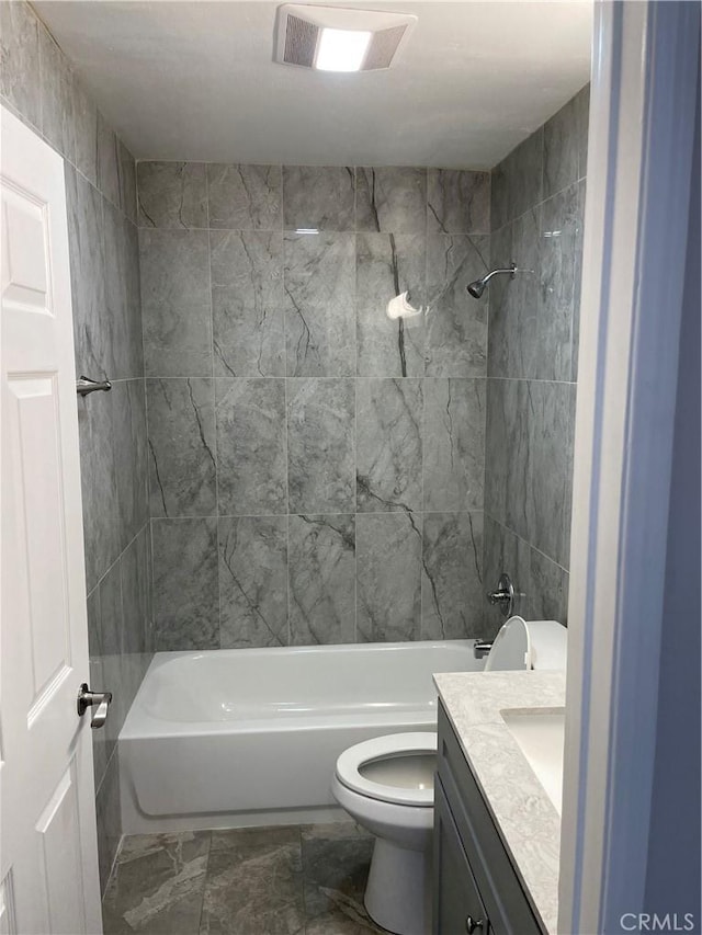 full bathroom with vanity, toilet, tile walls, and tiled shower / bath combo