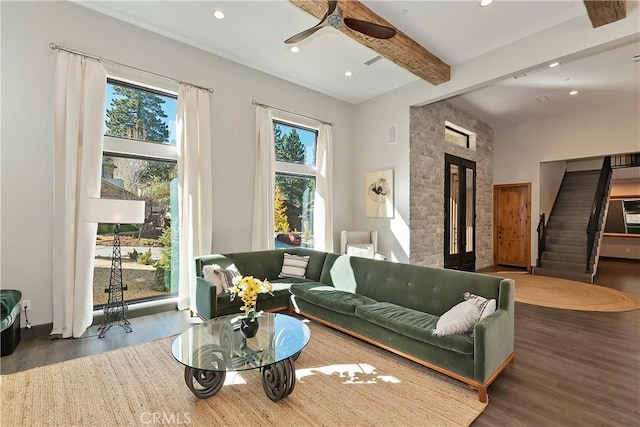 living room with beamed ceiling, a high ceiling, dark hardwood / wood-style floors, and ceiling fan