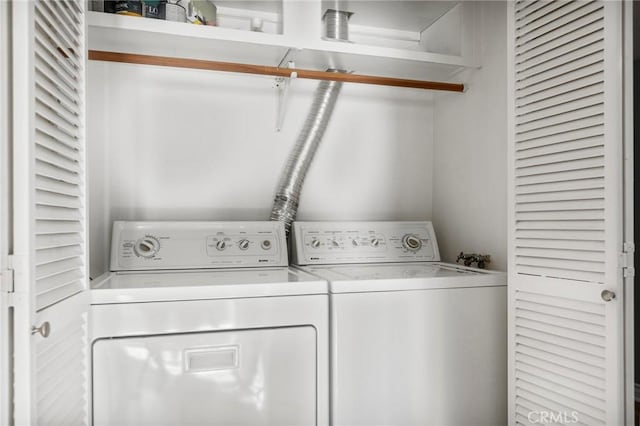 clothes washing area with washing machine and dryer