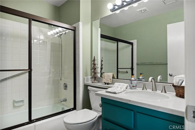 full bathroom with shower / bath combination with glass door, vanity, and toilet