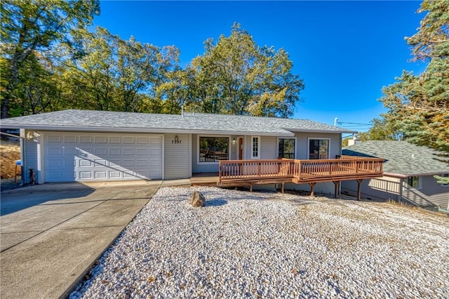 single story home with a deck and a garage