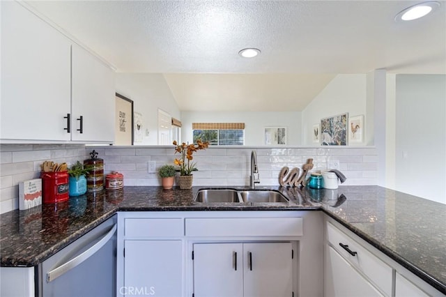 kitchen featuring backsplash, white cabinetry, sink, and dishwasher