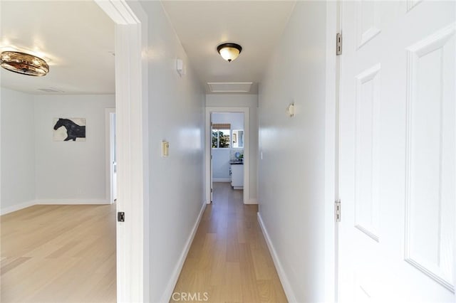 corridor with light hardwood / wood-style flooring