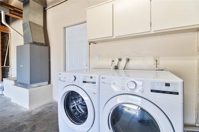 laundry area with cabinets and washing machine and clothes dryer