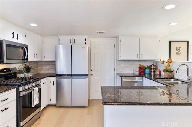 kitchen with light hardwood / wood-style floors, sink, white cabinetry, and stainless steel appliances