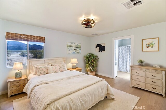 6556 Lupine Ave Unit 29, Palms, CA 92277 - bedroom with light wood-type flooring and baseboards