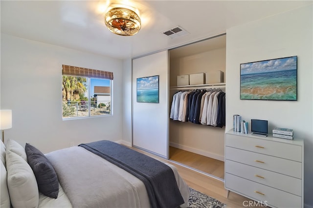 bedroom with a closet and light hardwood / wood-style flooring