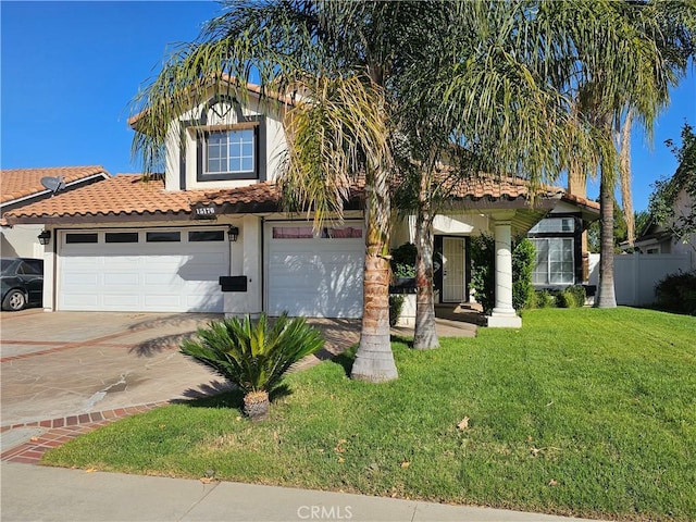 view of front of property featuring a front yard and a garage