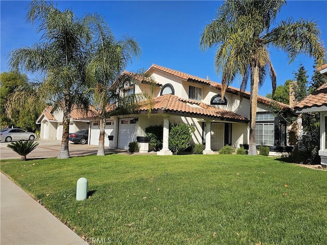 mediterranean / spanish-style home with a front lawn